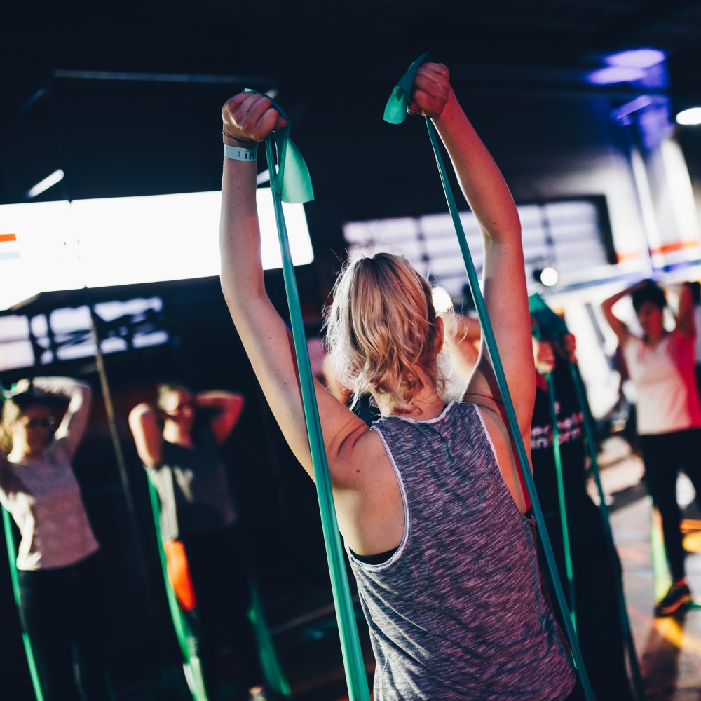 free weights and woman working out in the background using a machine