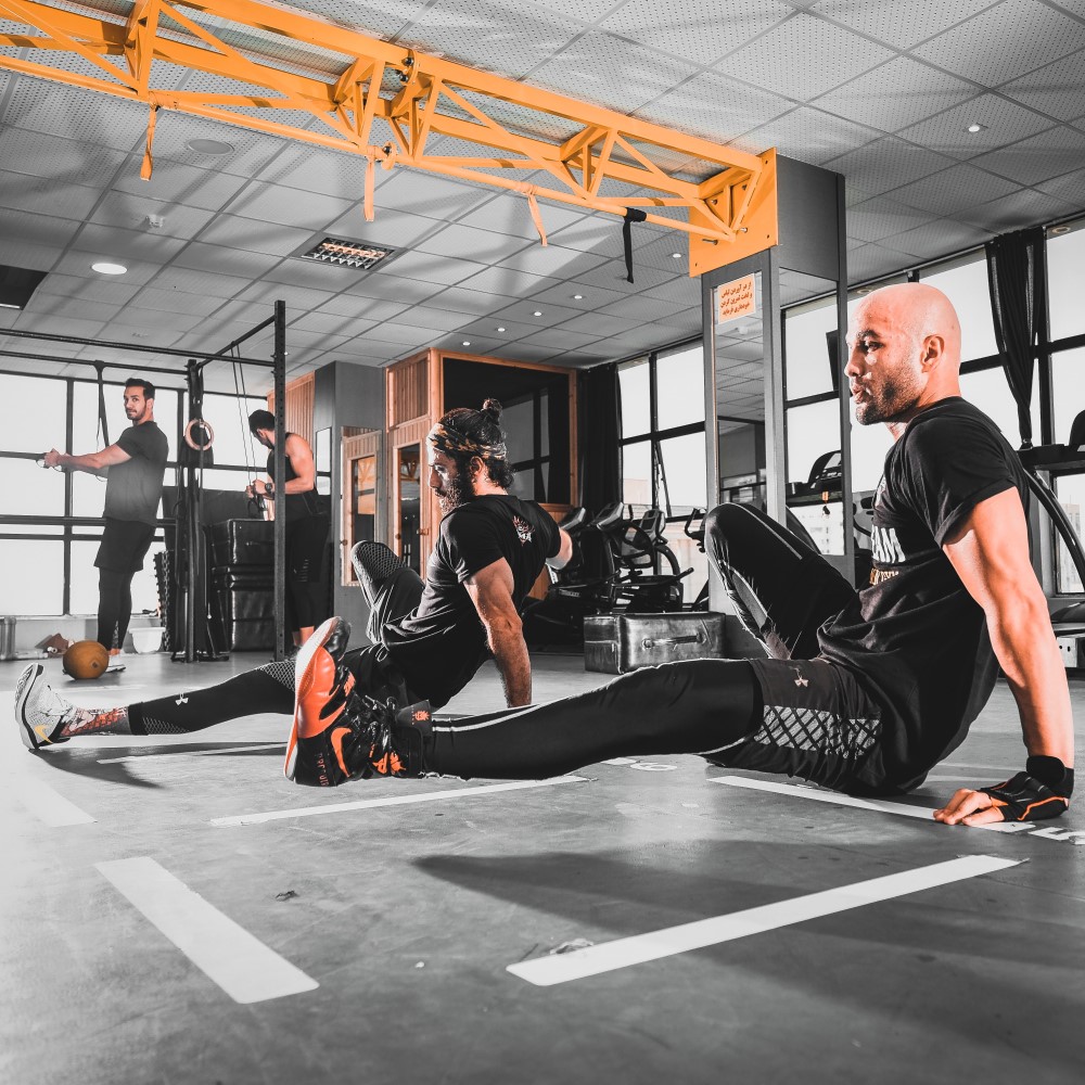 free weights and woman working out in the background using a machine